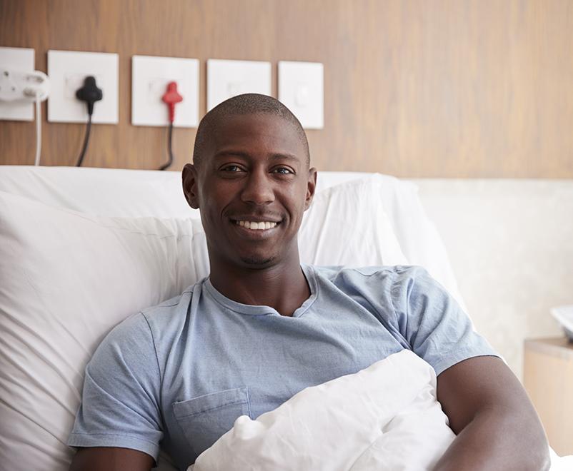 man smiling in hospital bed